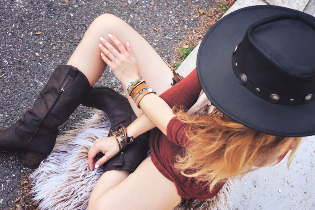 Retro Vintage Fashion
Woman in Rust Dress, Black hat and Boots